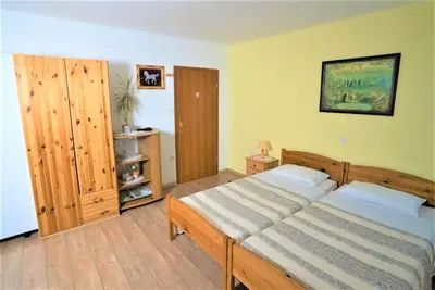 a bedroom with two beds in a room at Kmetija Podobnik in Idrija