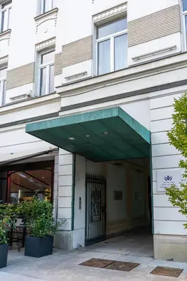 a building with a green awning over a door at Downtown Luxury Retreat in Ljubljana