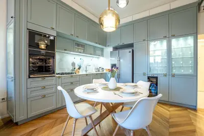 a kitchen with a white table and white chairs at Downtown Luxury Retreat in Ljubljana