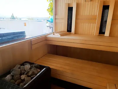 a sauna with a bin of rocks in it at Vila Frigo Olimia in Podplat