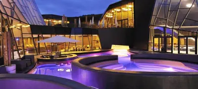 a building with a hot tub with purple lights at Vila Frigo Olimia in Podplat