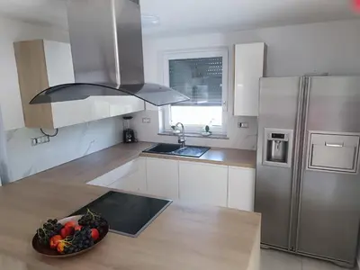 a kitchen with a bowl of fruit on the floor at Vila Frigo Olimia in Podplat