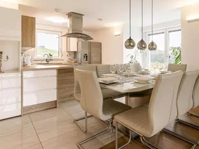 a kitchen and dining room with a table and chairs at Vila Frigo Olimia in Podplat