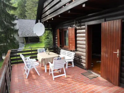 a patio with a table and chairs on a house at Holiday Home Gobela in Kranjska Gora