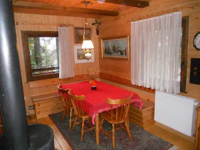 a dining room with a red table and chairs at Holiday Home Gobela in Kranjska Gora