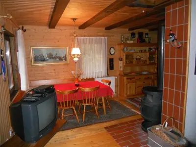 a dining room with a table and a television in a cabin at Holiday Home Gobela in Kranjska Gora