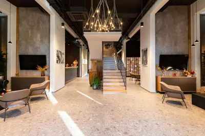 a hallway with chairs and stairs in a building at Hotel Lonca in Škofja Loka