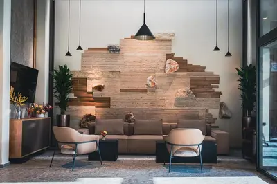 a lobby with a couch and two chairs at Hotel Lonca in Škofja Loka