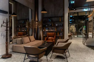 a living room with a couch and chairs at Hotel Lonca in Škofja Loka