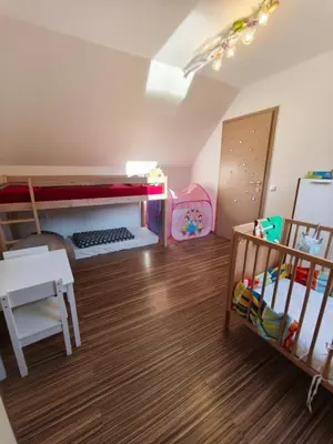 a room with a bunk bed and a crib at Riverside Guesthouse in Ig
