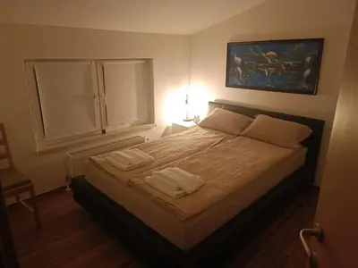 a bedroom with a bed with two towels on it at Riverside Guesthouse in Ig