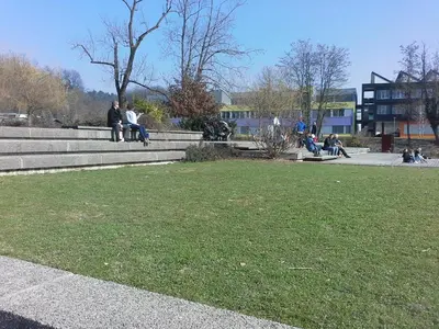 a group of people sitting on the stairs in a park at Studio My Ljubljana Home in Ljubljana