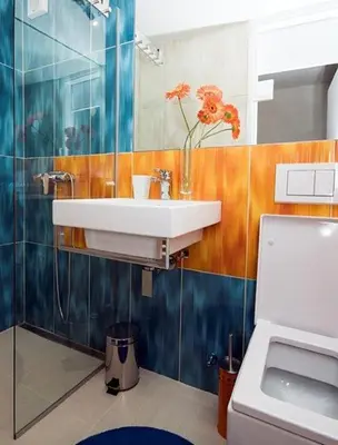a bathroom with a sink and a vase of flowers at Studio My Ljubljana Home in Ljubljana