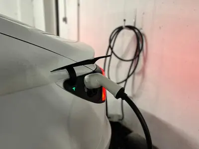 a car is plugged into a wall with a wire at Diamant apartment pri sejmu MOS in Celje