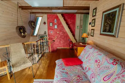 a living room with a couch and a staircase at Chalet Alpinka in Cerklje na Gorenjskem