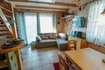 a living room with a couch and a table at Chalet Alpinka in Cerklje na Gorenjskem