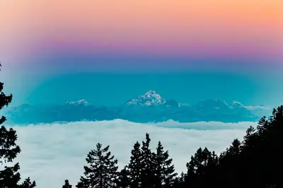 a rainbow colored sky with a mountain in the background at Chalet Alpinka in Cerklje na Gorenjskem