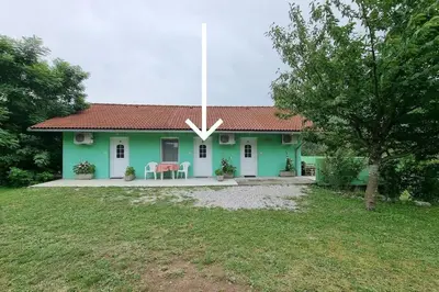 a small green house with a red roof at Apartma Patricija for 2 in Tolmin