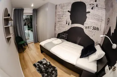 a bedroom with a bed and a wall with a man silhouette at Ljubljana Urban Apartments - Quiet Stay & Free Parking in Ljubljana