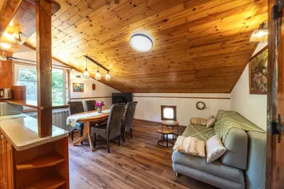 a living room with a couch and a table at The Hug of Nature in Dekani
