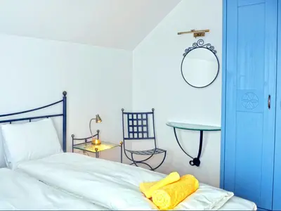 a bedroom with a bed and a table and a mirror at Apartment Galerija in Radovljica