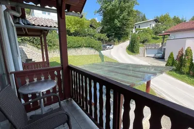 a glass table on the balcony of a house at Family House Simba in Smarjeske Toplice