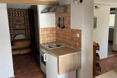 a kitchen with a stove and a counter top at Family House Simba in Smarjeske Toplice