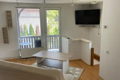 a living room with a couch and a table and a tv at Family House Simba in Smarjeske Toplice