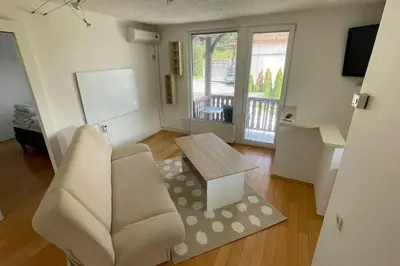 a living room with a couch and a table at Family House Simba in Smarjeske Toplice