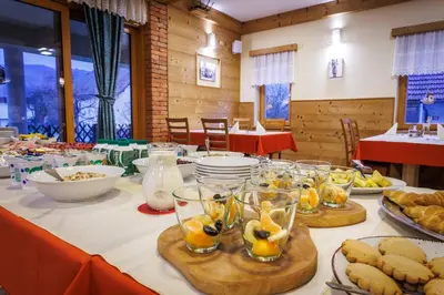 a table topped with plates and bowls of food at Hotel Vegov Hram in Dol pri Ljubljani