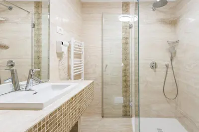 a bathroom with a sink and a shower at Hotel Vegov Hram in Dol pri Ljubljani