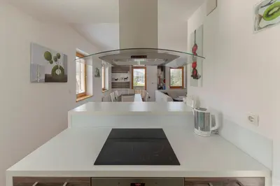 a kitchen with a white counter top in a room at Sunee Apartment in Kranjska Gora