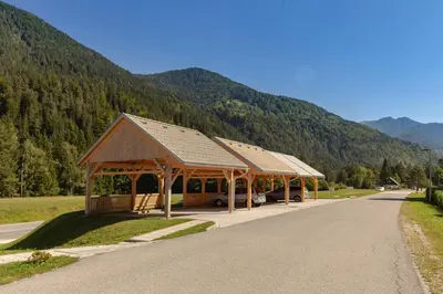 a pavilion with a bus parked in a road at Sunee Apartment in Kranjska Gora