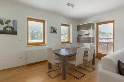 a dining room with a table and chairs at Sunee Apartment in Kranjska Gora