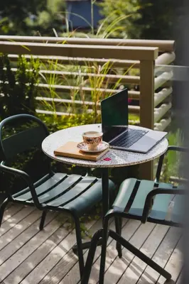 a laptop sitting on a table on a deck at AS Boutique Hotel, superior in Ljubljana