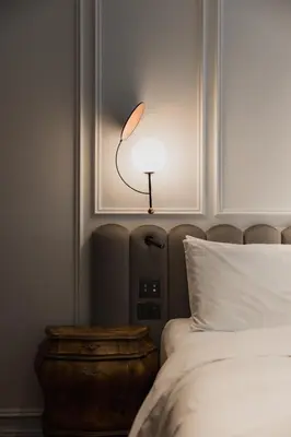 a bedroom with a bed with a lamp on it at AS Boutique Hotel, superior in Ljubljana