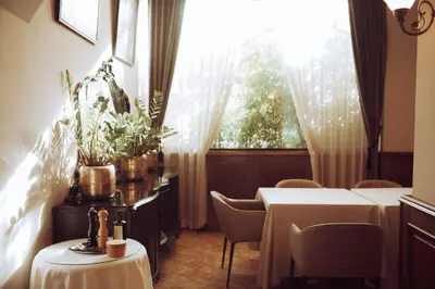 a dining room with two tables and a window at AS Boutique Hotel, superior in Ljubljana