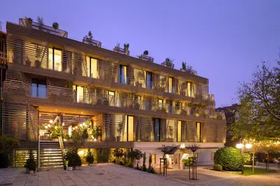 a large building with lights on the side of it at AS Boutique Hotel, superior in Ljubljana