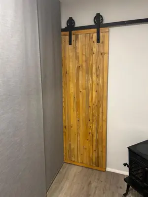 a wooden door in a room with a wall at APARTMENT GAL in Novo Mesto