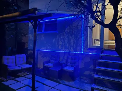 a set of stairs with chairs and a blue light at APARTMENT GAL in Novo Mesto