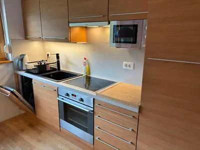 a small kitchen with a stove and a sink at Apartment Lesnina in Kranjska Gora