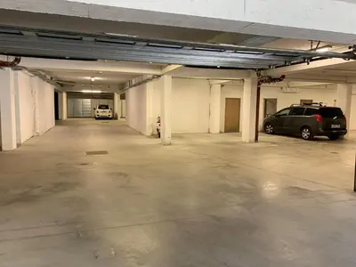 an empty parking garage with two cars parked in it at Apartment Lesnina in Kranjska Gora