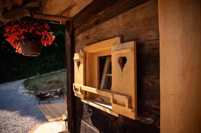a wooden box with a heart on a wall at Tiny House - Glamping Paradise Skatlar 45722 in Otočec