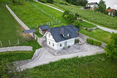 a white house with a black roof on a hill at Holiday home in Smarjeske Toplice - Kranjska Krain 45723 in Smarjeske Toplice