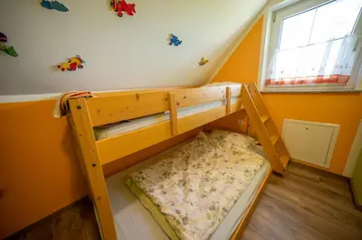 a bunk bed in a room with orange walls at Nebesa so tudi na zemlji in Tomaž pri Ormožu