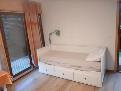 a white bed in a room with a window at Nebesa so tudi na zemlji in Tomaž pri Ormožu