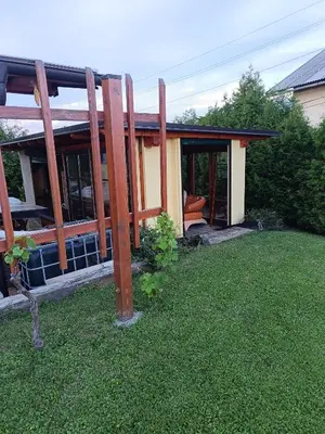 a house with a porch and a yard at Nebesa so tudi na zemlji in Tomaž pri Ormožu