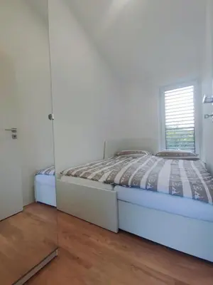 a bedroom with a bed and a mirror at Holiday house Sara in Kozina
