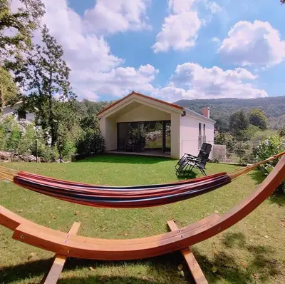 a large hammock in the yard of a house at Holiday house Sara in Kozina