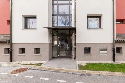 a building with a glass door on the side of it at Cadys Apartment in Kranjska Gora